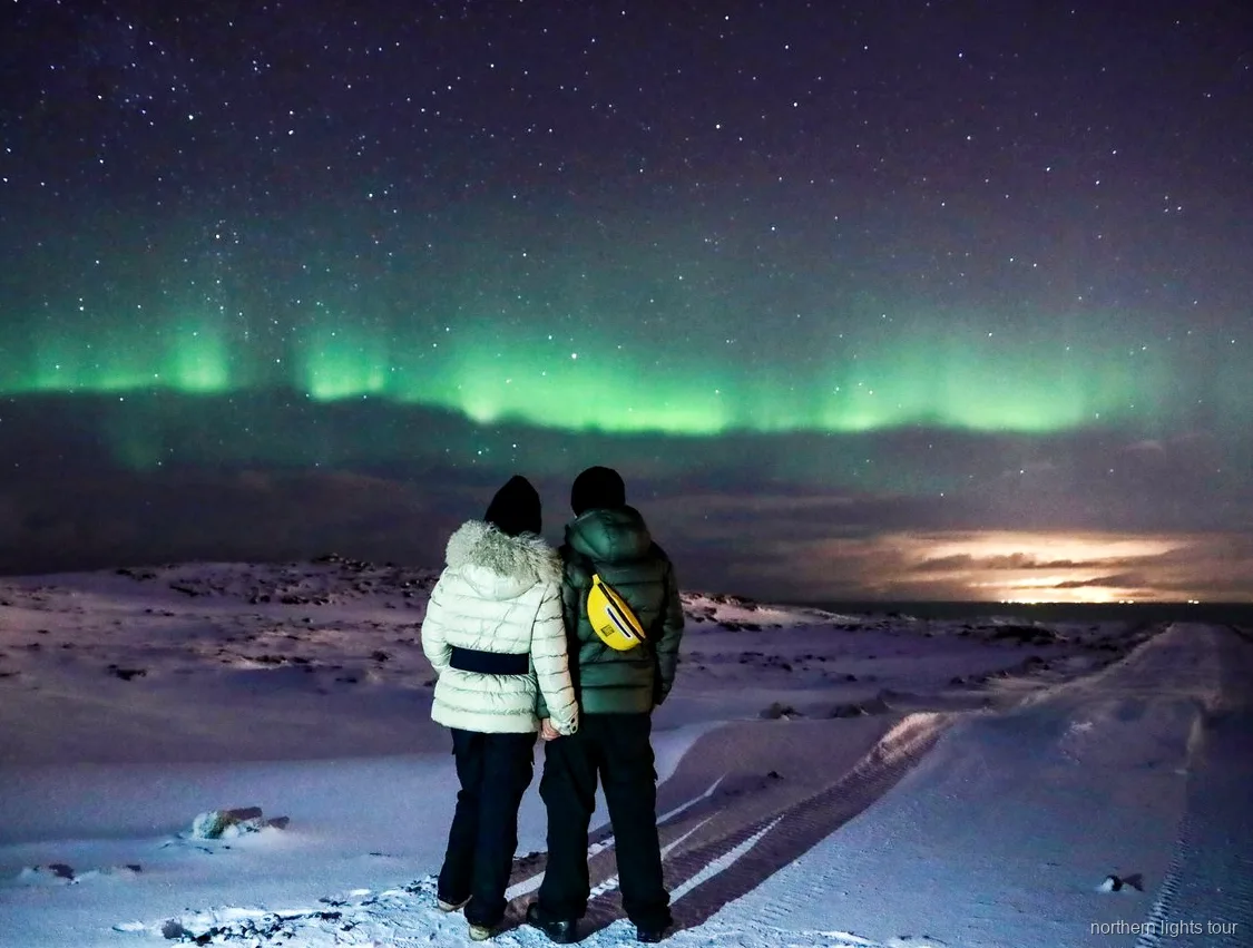 Guests drinking hot cocoa on the Reykjavik Northern Lights bus tour